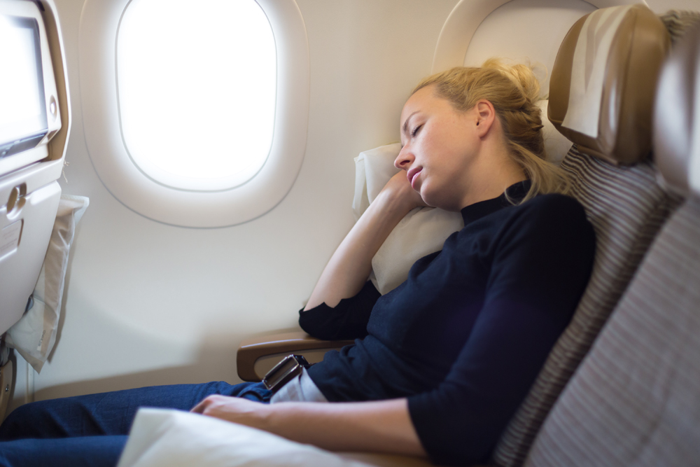 woman sleeping on an airplane